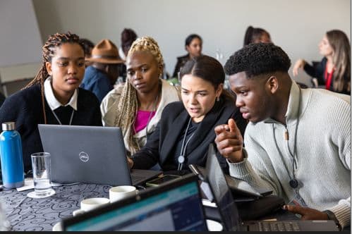 David working through a problem on screen with a group