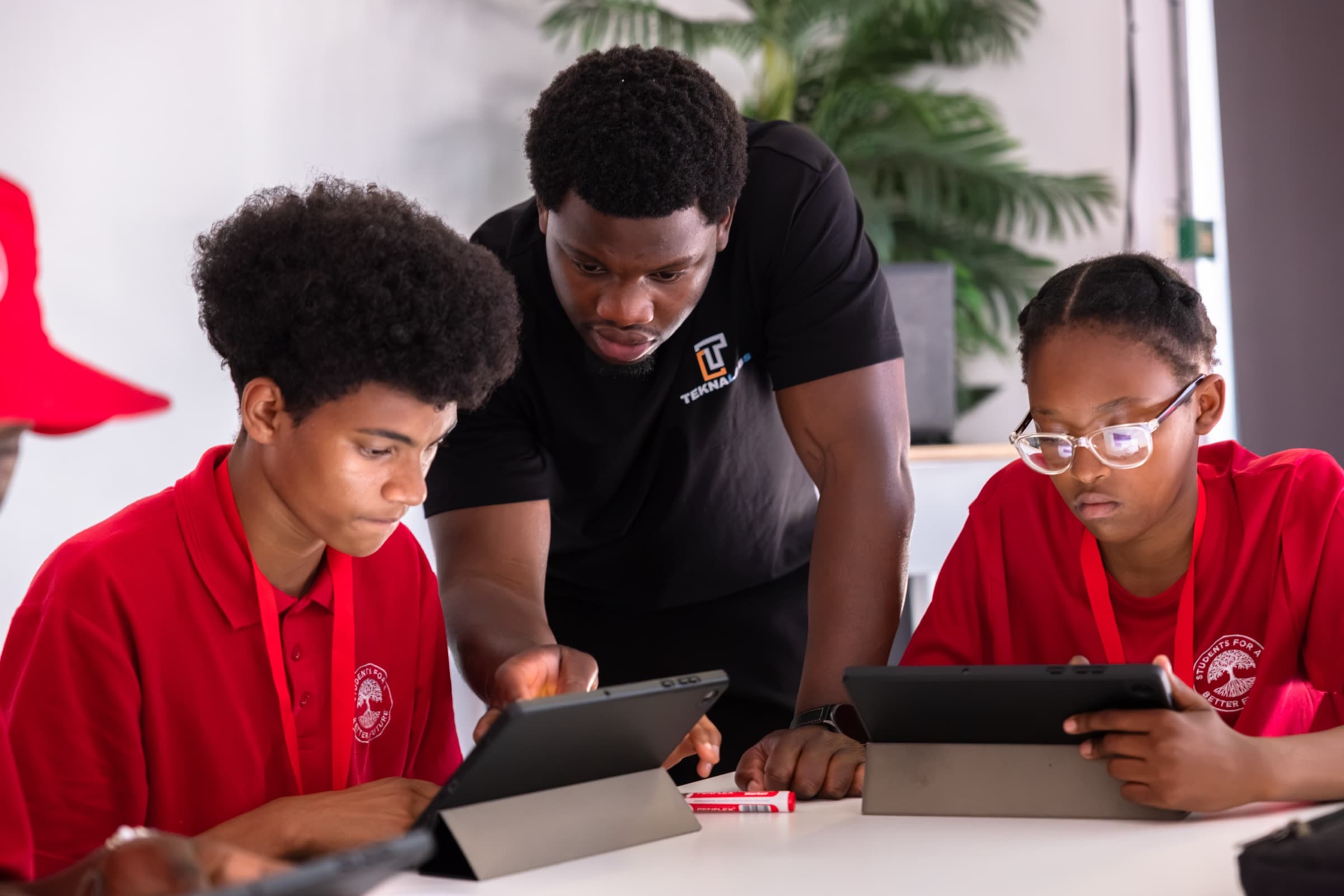 David working through an exercise with students on tablets