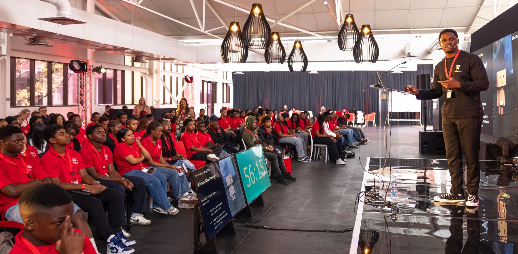 David on stage at a TeknaLabs session with over a hundred students